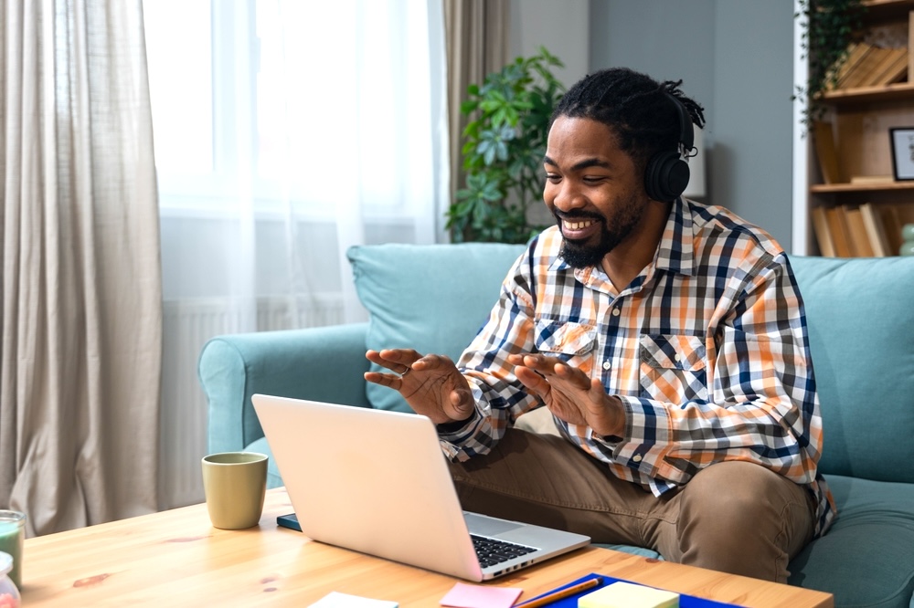 Male smiling at his therapist during online depression therapy