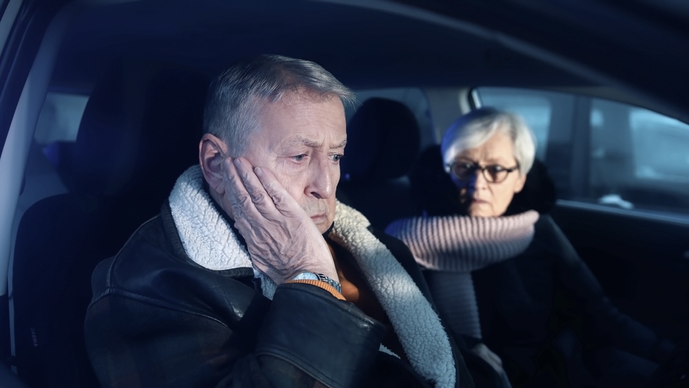 Elderly man telling his wife he is embarrassed to go to therapy