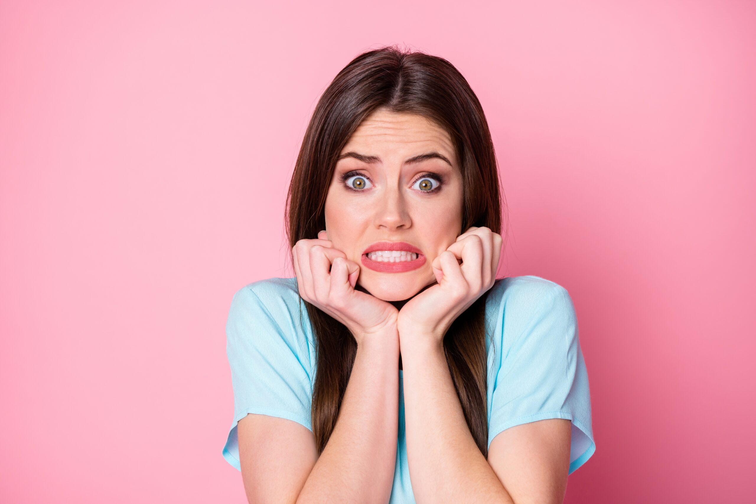 Woman in blue shirt embarrassed about going to therapy