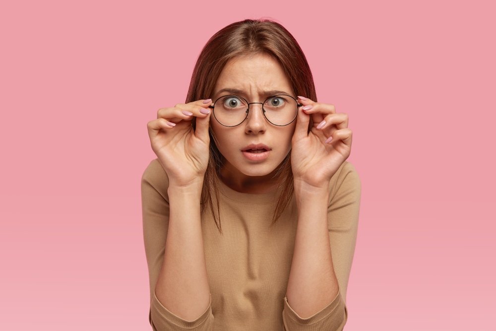 Female wearing glasses looking shocked after learning mental health myths