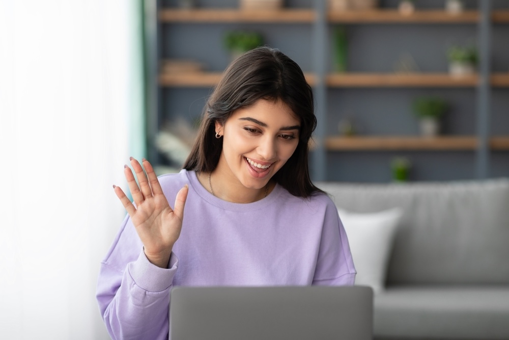 Woman saying hello to her therapist during virtual mental health treatment