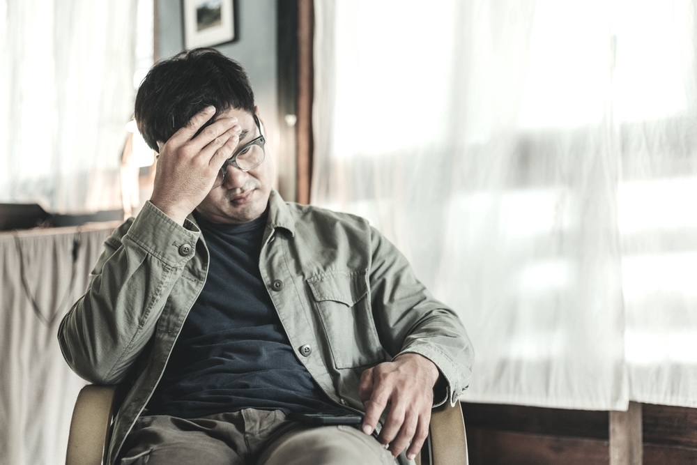 Man wearing glasses struggling with anxiety wondering about the Xanax bar yellow drug